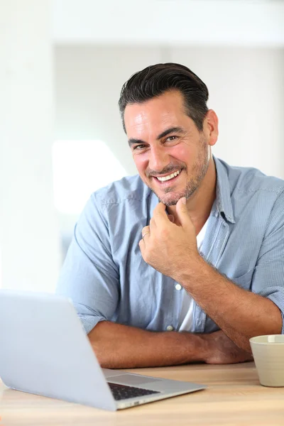Man working at home with laptop — Stock Photo, Image