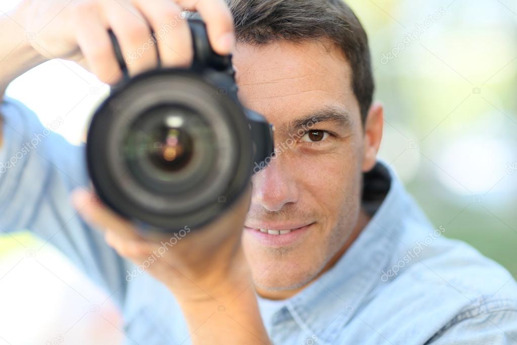 Photographer using reflex camera outside