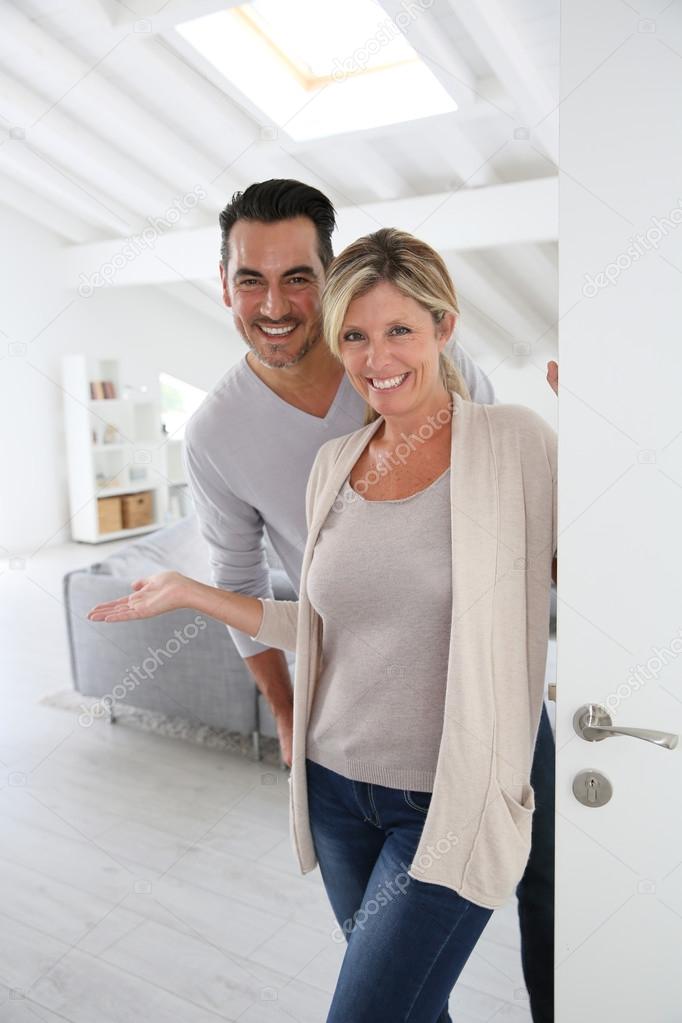 Mature couple standing at home