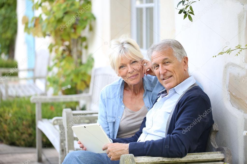 Senior couple websurfing on internet