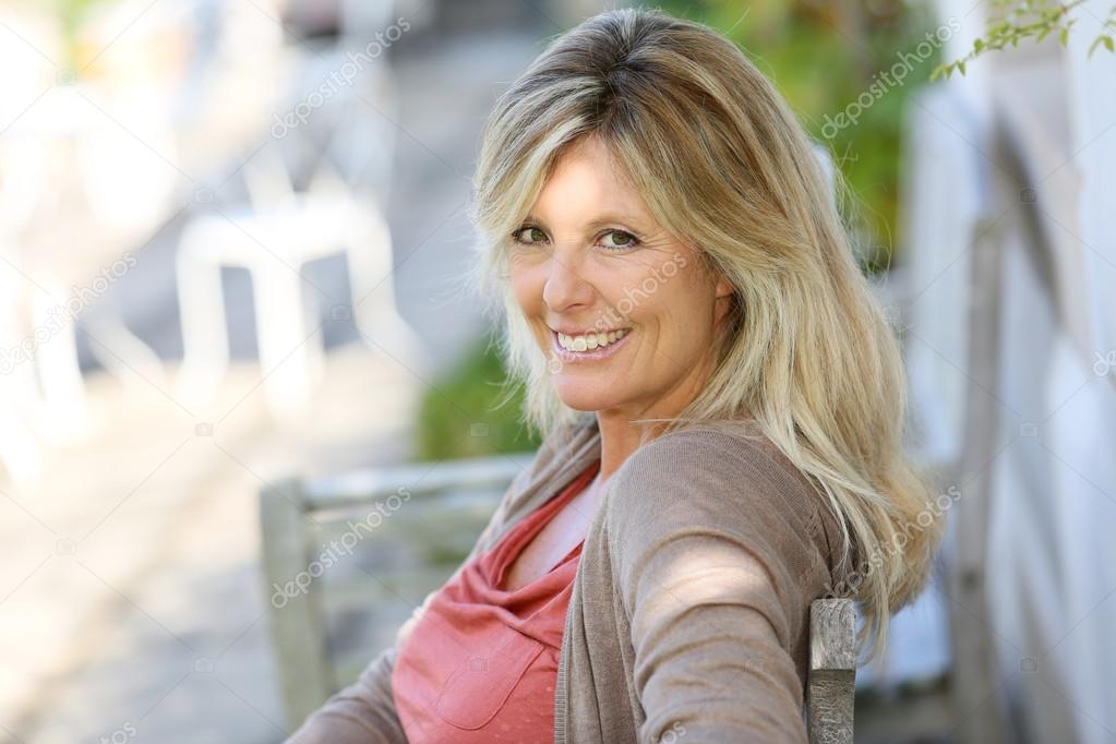 Woman relaxing in outdoor bench