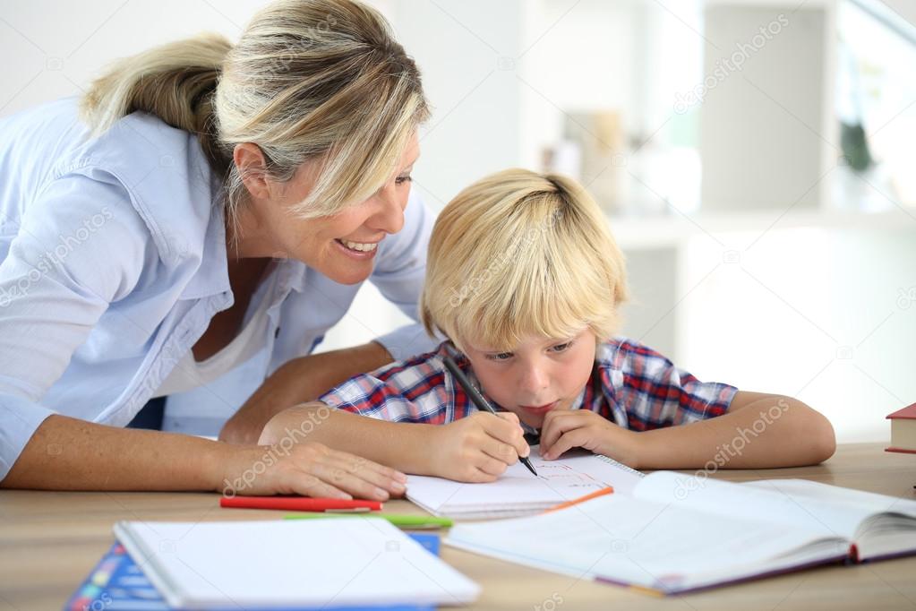 Mom helping boy to do homework