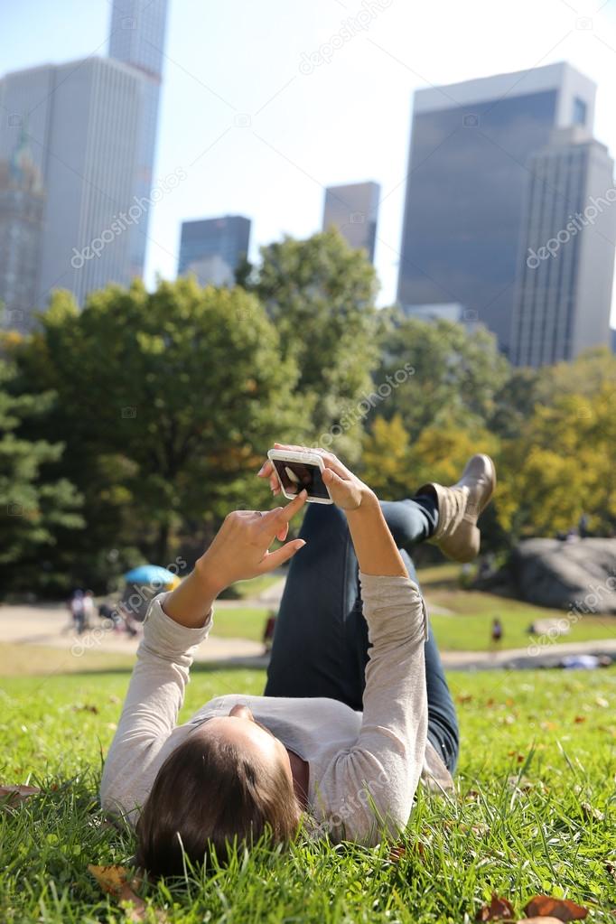 Woman in Central Park using smartphone