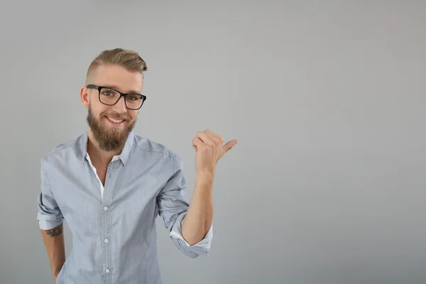 Trendy guy pointing at message — Stock Photo, Image