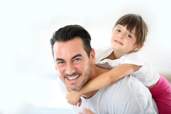 Daddy carrying little girl on back — Stock Photo, Image