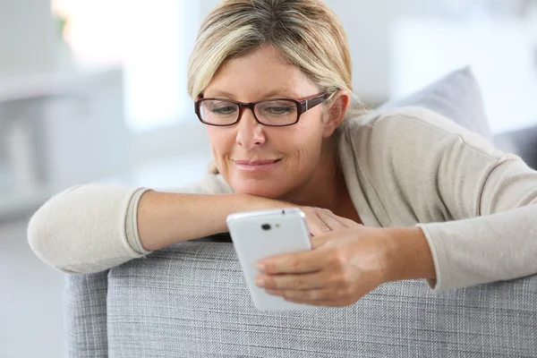 Mujer leyendo mensaje en el teléfono inteligente — Foto de Stock