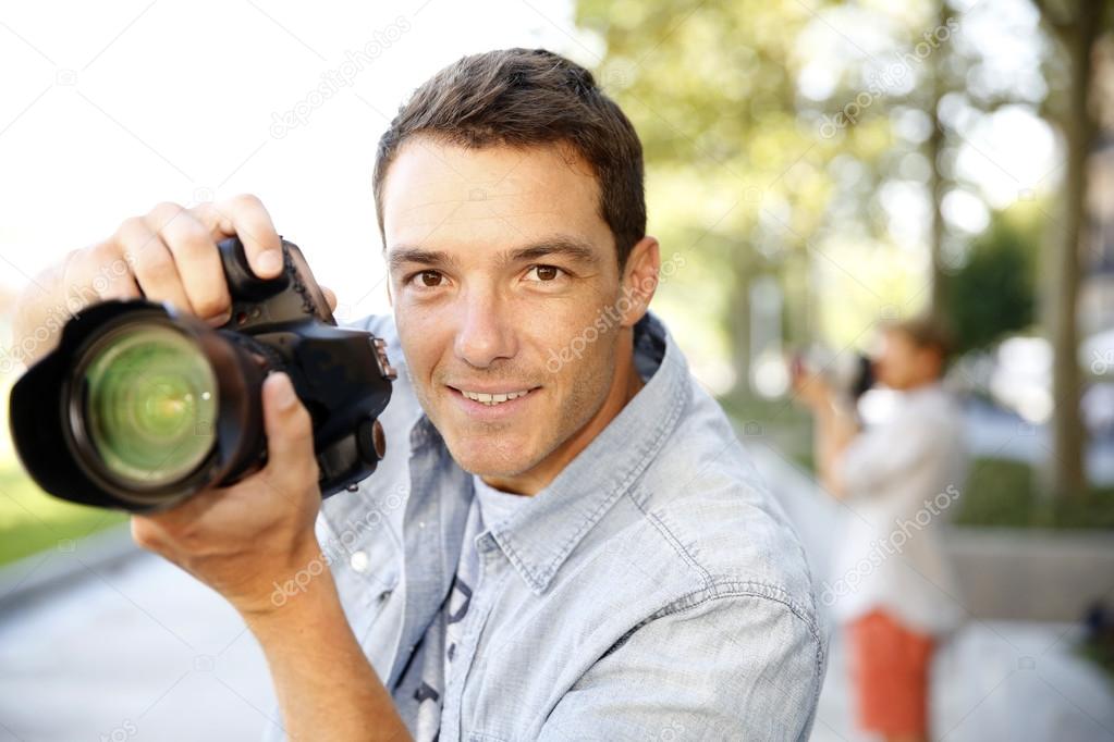Photographer taking pictures in street