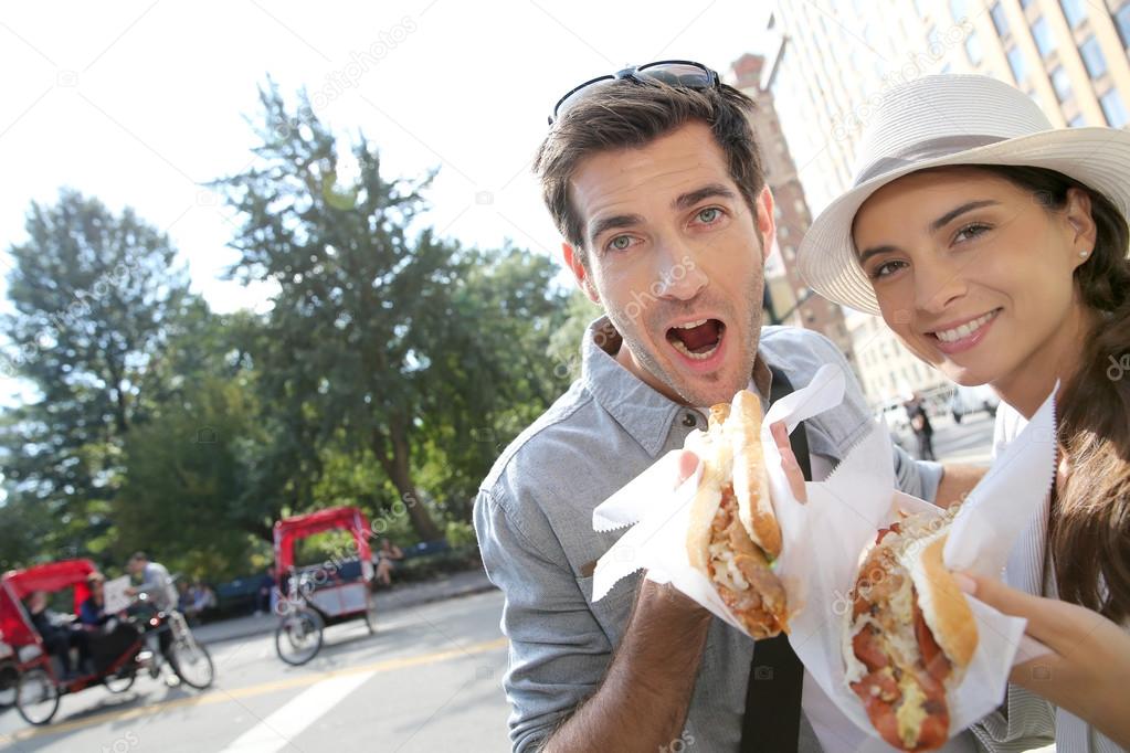 Tourists in New York eating hot dogs