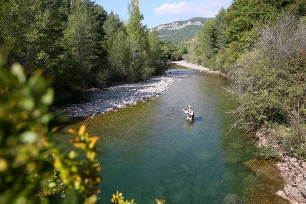 Fisherman fly-fishing in river — Stock Photo, Image