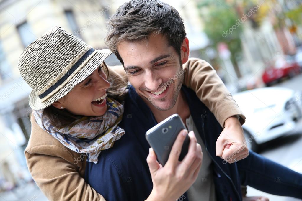 Couple playing with smartphone