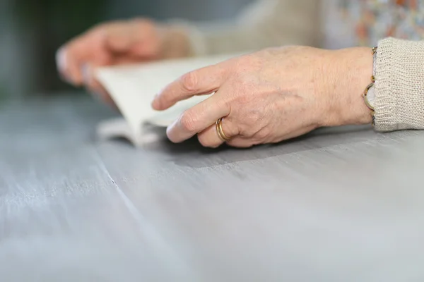 Elderly woman with book — Stock Photo, Image