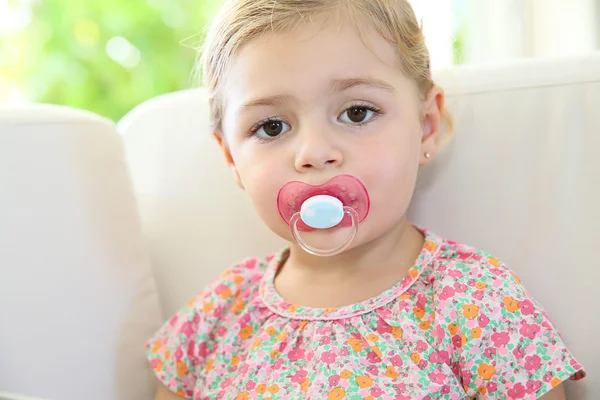 Cute girl with dummy — Stock Photo, Image