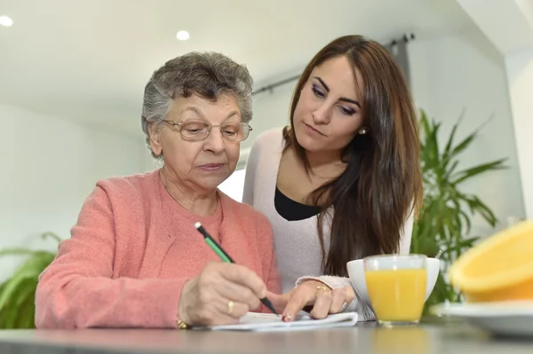 Elderly woman doing crossword Royalty Free Stock Images