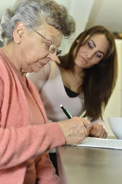 老年妇女做填字游戏 免版税图库图片