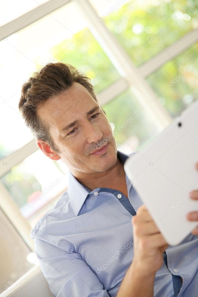 Man at home using tablet