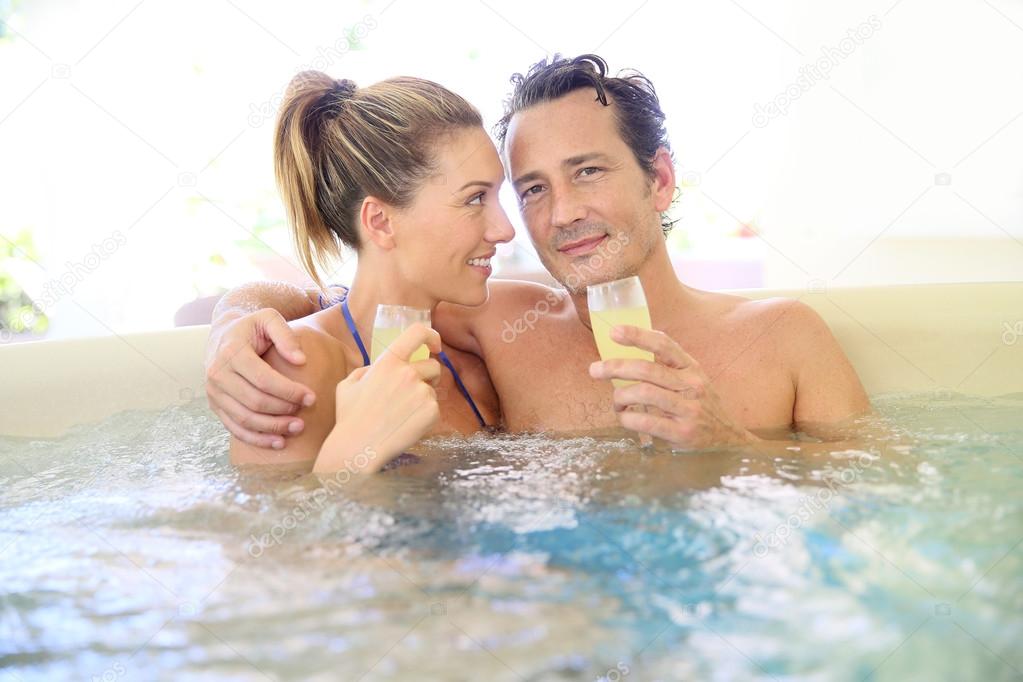 Couple drinking cahmpagne in tub