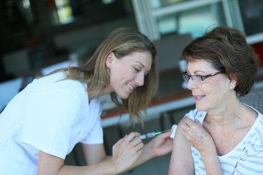 Woman receiving flu vaccine clipart