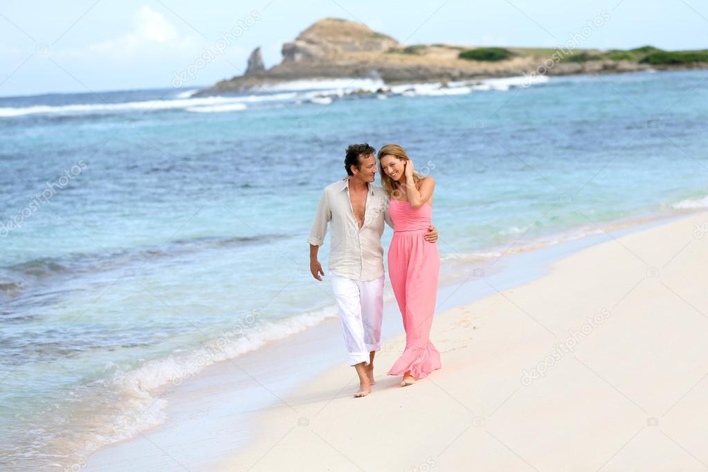 Couple walking on sandy beach