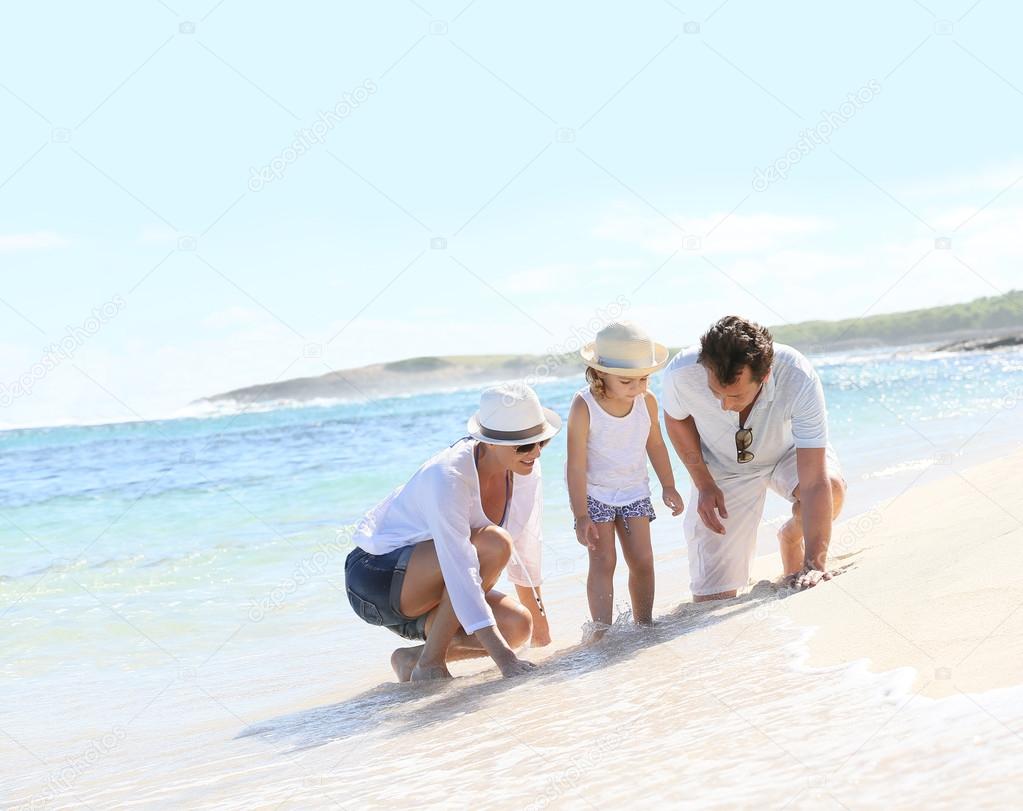 Parents and child playing on beach