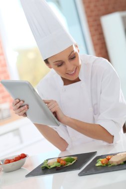 Cook using digital tablet clipart