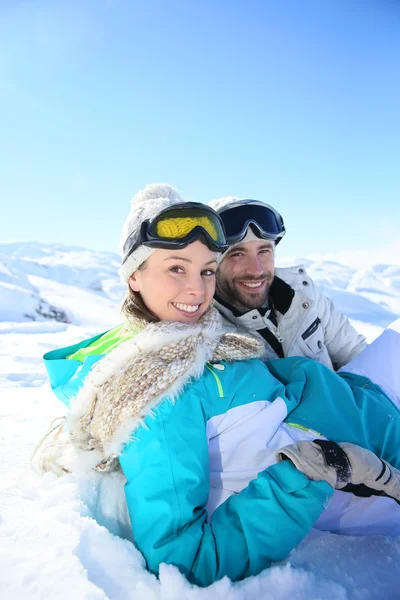 Paar zitten in de sneeuw — Stockfoto