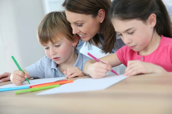 Moeder kijken kinderen tekenen — Stockfoto