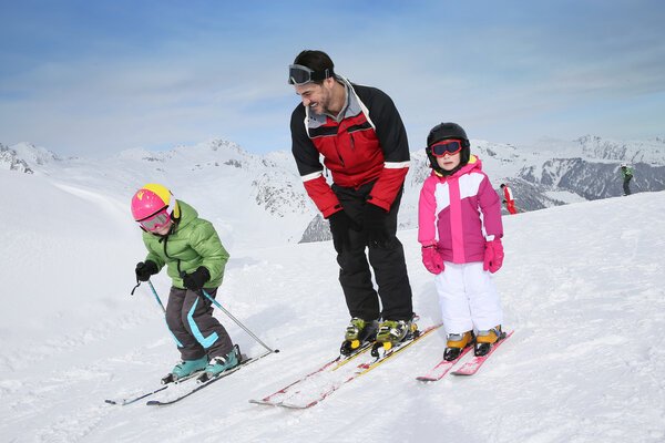 Ski teacher helping kids
