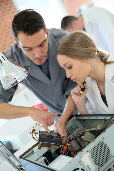 Teacher with student repairing computer — Stock Photo, Image