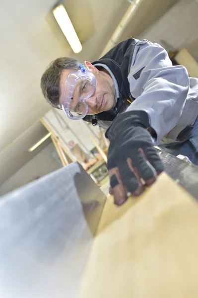 Worker working with wood plank — Stock Photo, Image