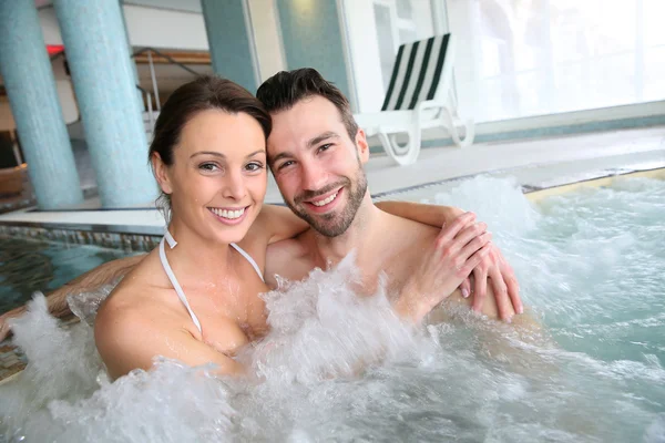 Couple in spa center jacuzzi — Stock Photo, Image