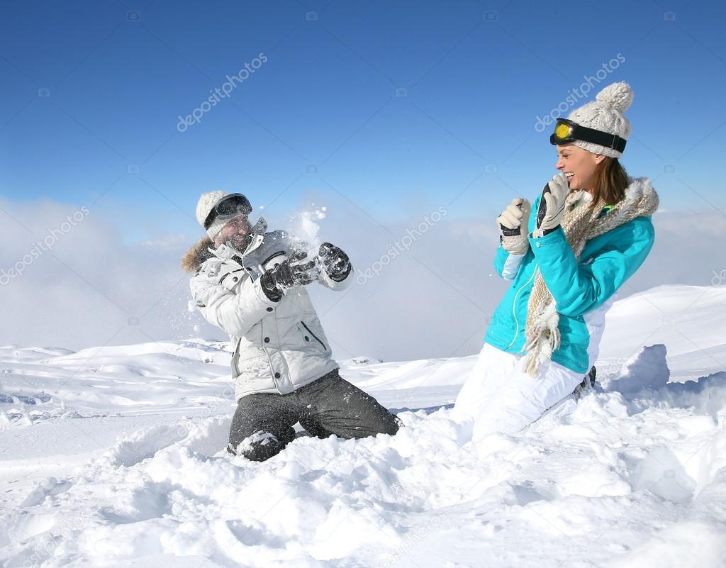 Couple doing snowballs fight