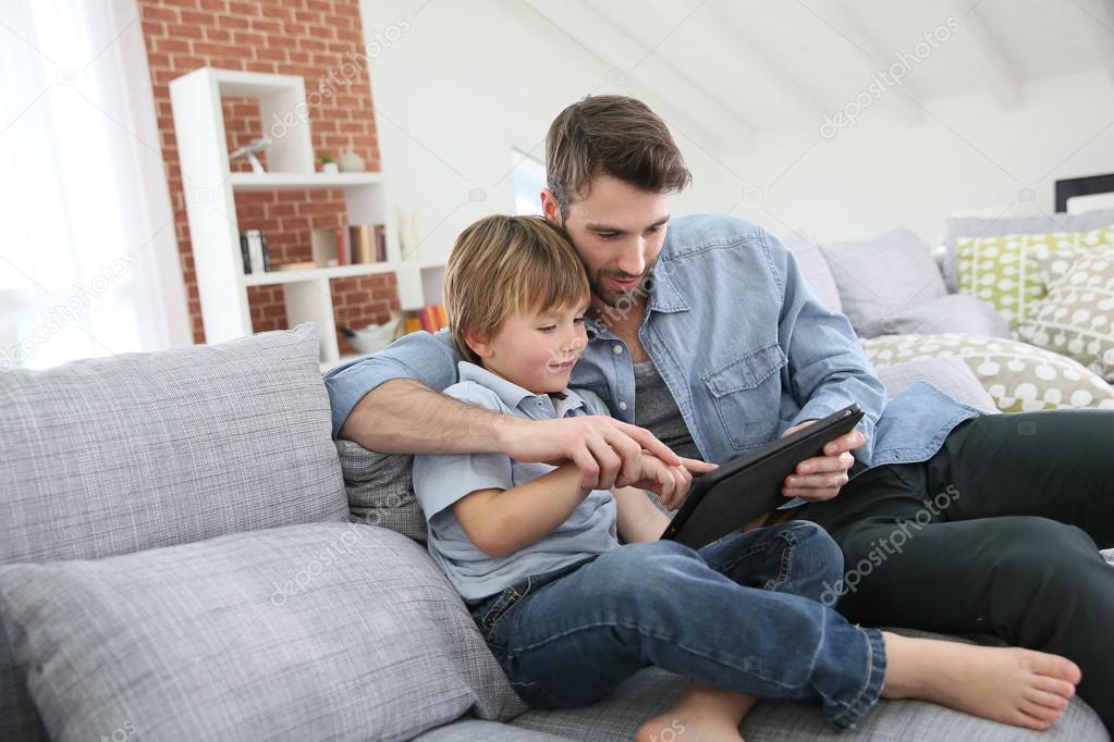 Father with boy using tablet