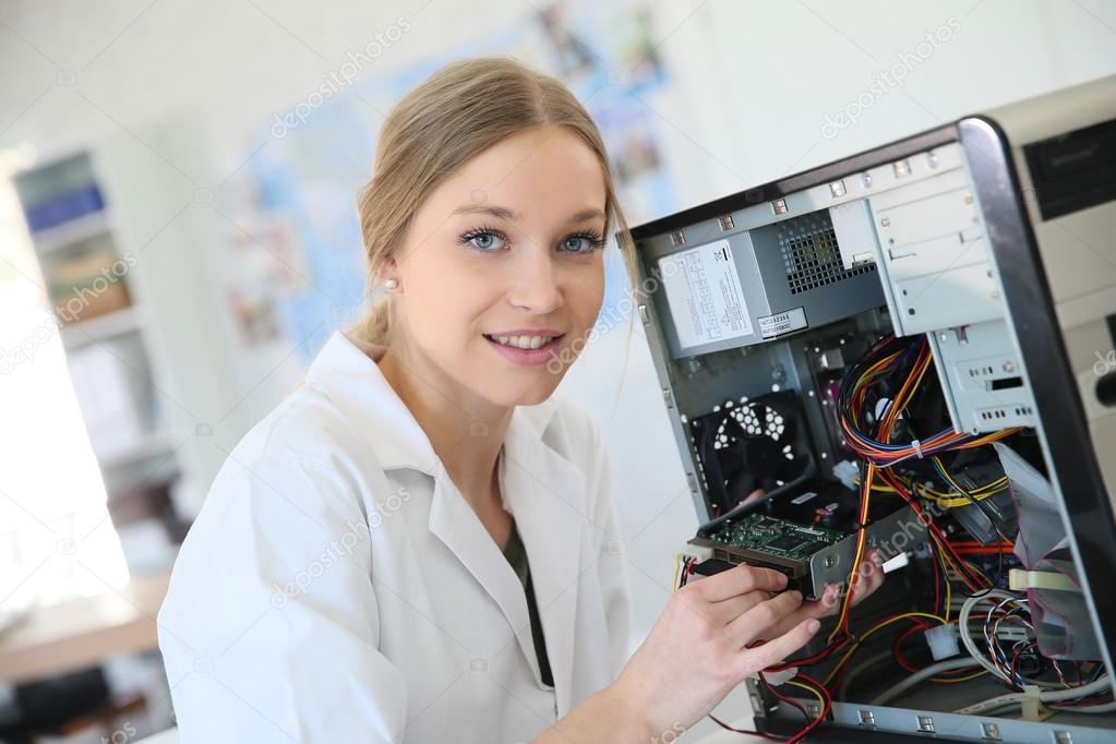 Girl fixing computer hard drive