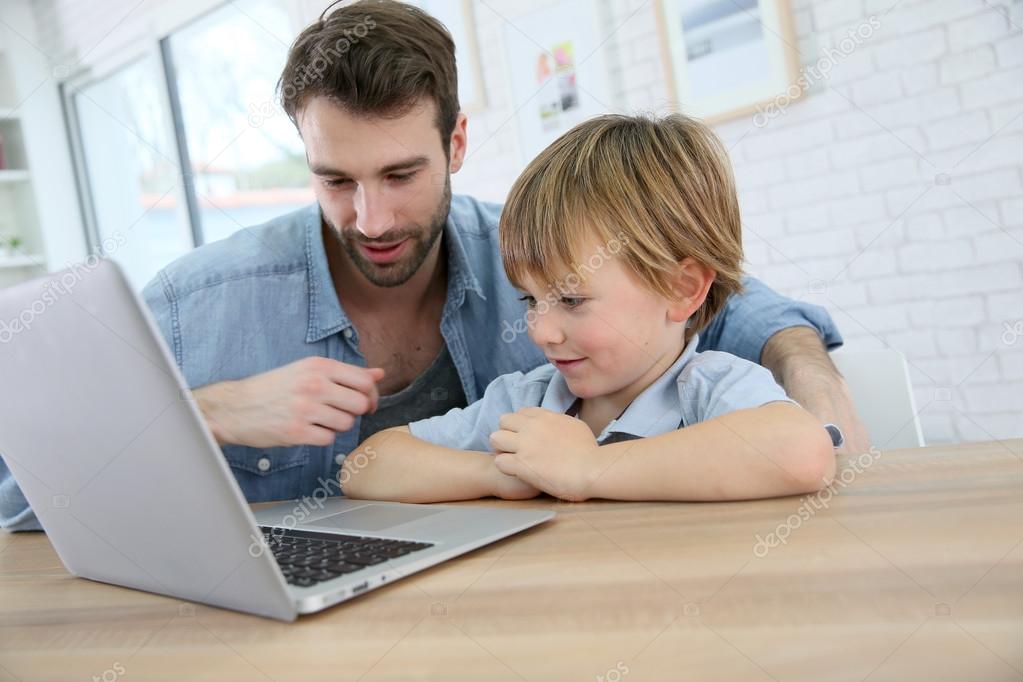 Daddy and son playing on laptop