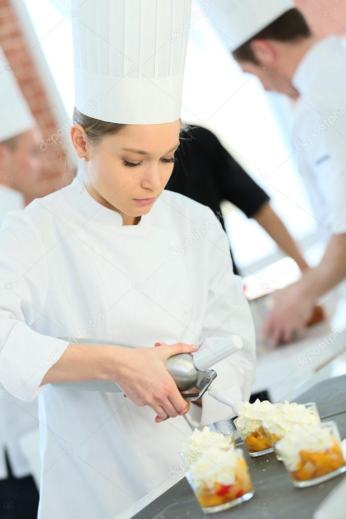 Pastry cook spreading whipped cream