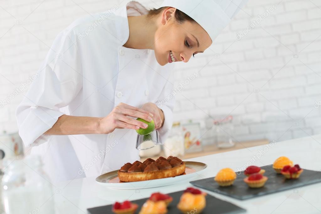 Pastry-cook shredding lemon zest