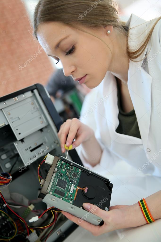 Student girl fixing computer Stock Photo by ©Goodluz 67893795