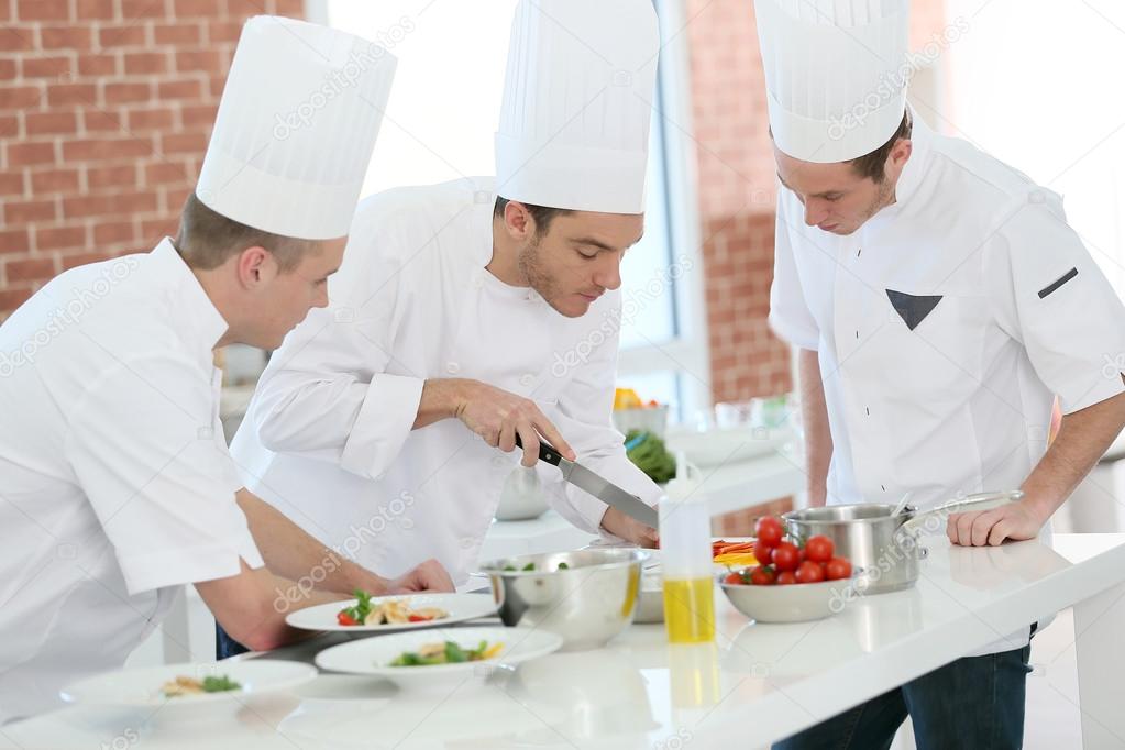 Chef training students in kitchen