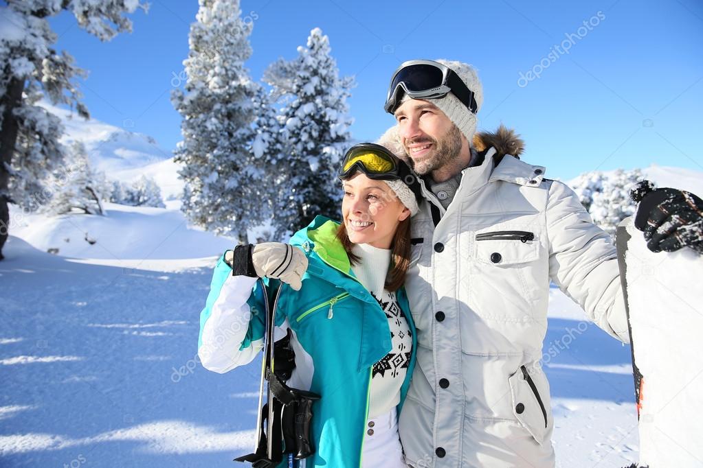 Skiers looking at snowy scenery