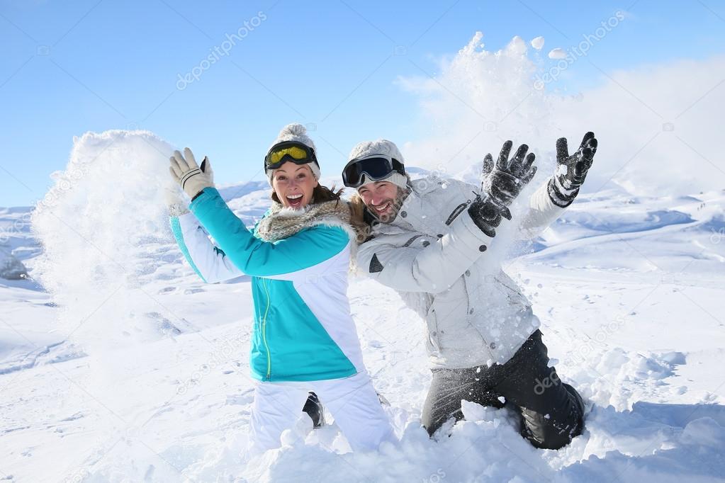 Couple doing snowballs fight