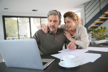 Couple calculating financial savings clipart