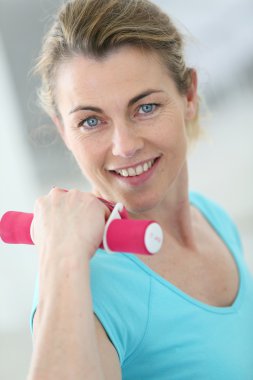 Woman lifting dumbbells clipart
