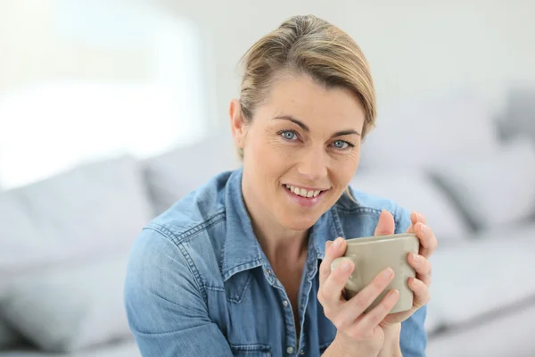 Woman with hot drink — Stock Photo, Image