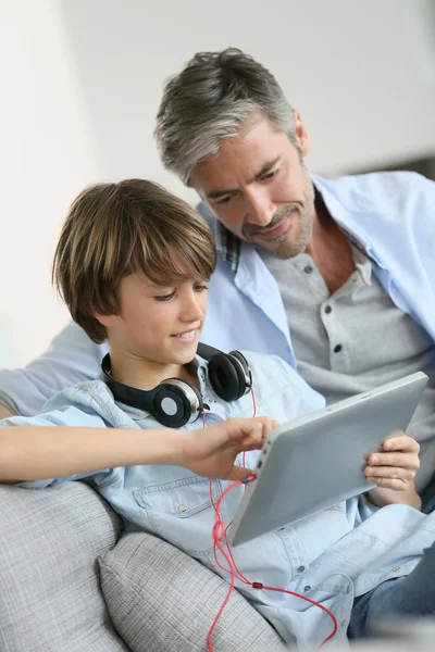 Père regardant enfant jouer avec la tablette — Photo