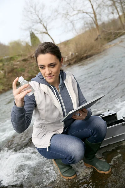 Student taking sample of water — Stock Photo, Image