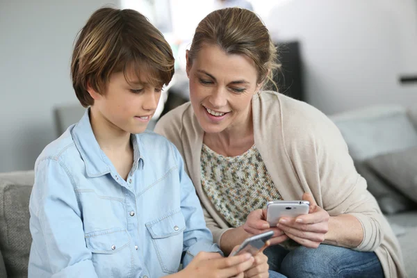 Мать и мальчик играют со смартфоном — стоковое фото