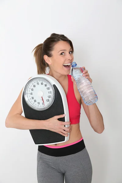 Girl with bottle of water and scale — Stock Photo, Image