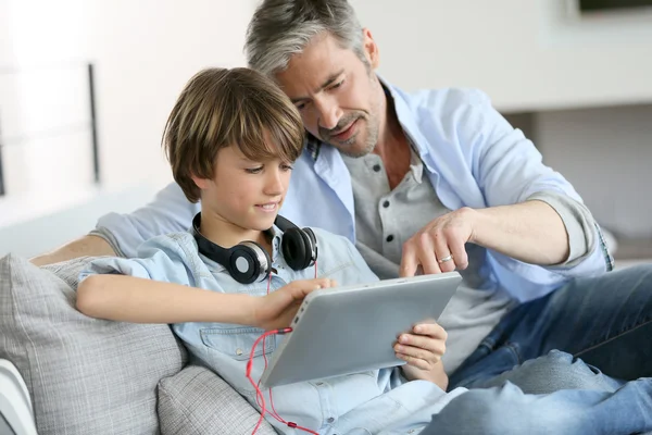 Vader kijken kind spelen met Tablet PC — Stockfoto