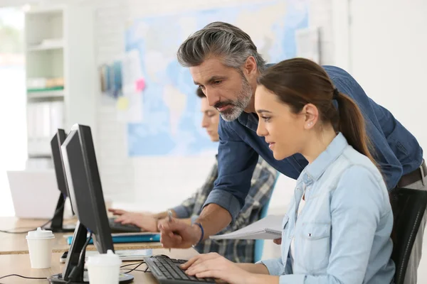 Trainer met studenten die werken — Stockfoto