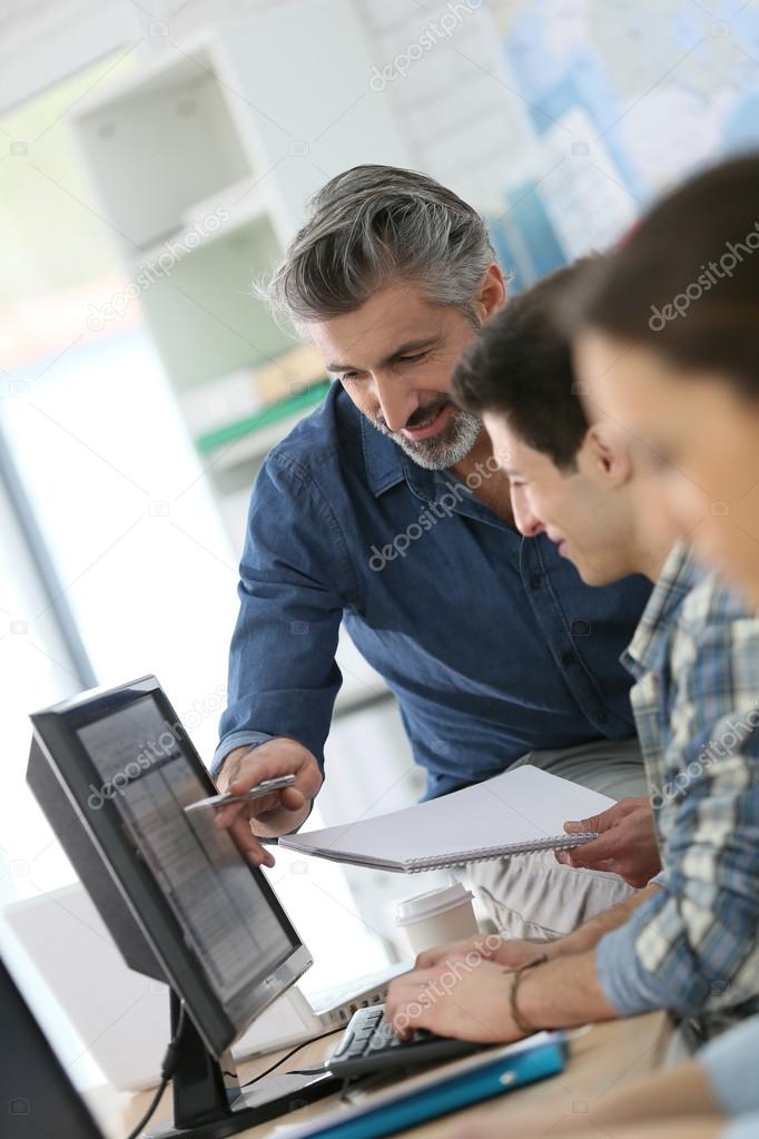 Teacher with people in computing class